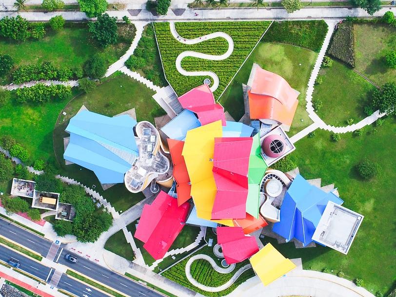aerial view of multicolored roof building next to road